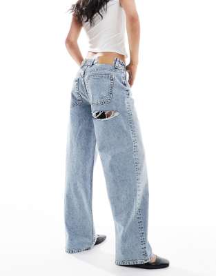 mid rise baggy boyfriend jeans with cheeky rip in mid blue