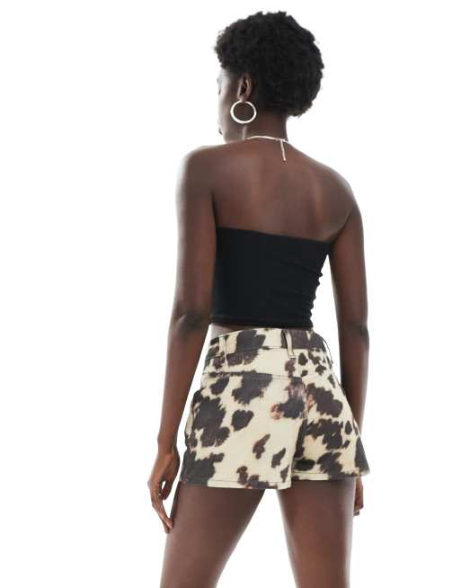 ASOS DESIGN mid rise denim micro shorts in cow print