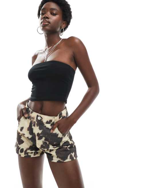 ASOS DESIGN mid rise denim micro shorts in cow print