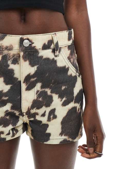 ASOS DESIGN mid rise denim micro shorts in cow print