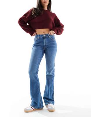 ASOS DESIGN mid rise flare jeans in authentic mid wash-Navy