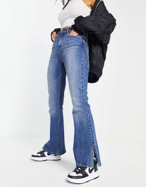 ASOS DESIGN mid rise flare jeans in dark blue with split hem