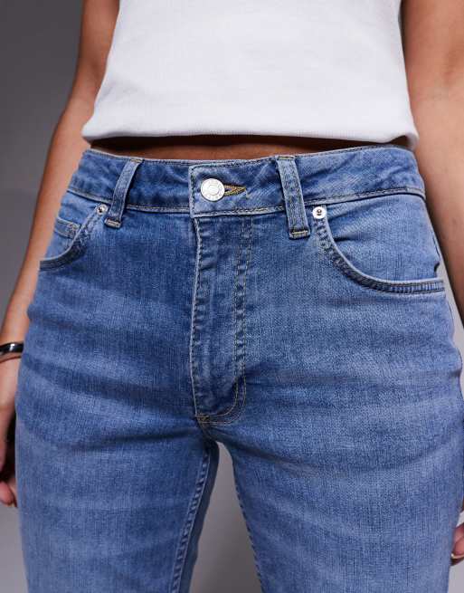 ASOS DESIGN mid rise flare jeans in mid wash