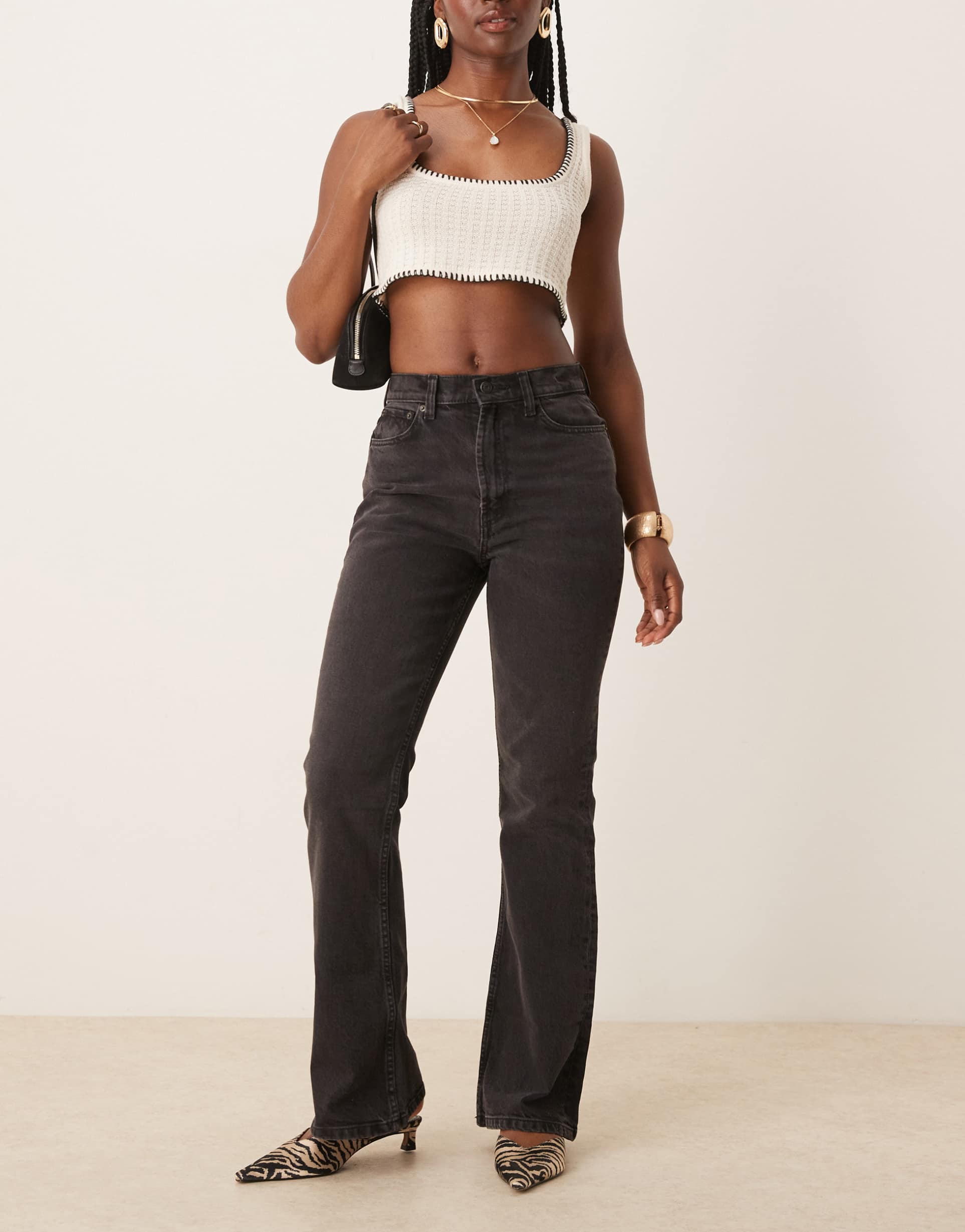 asos design mid rise flare jeans in washed black