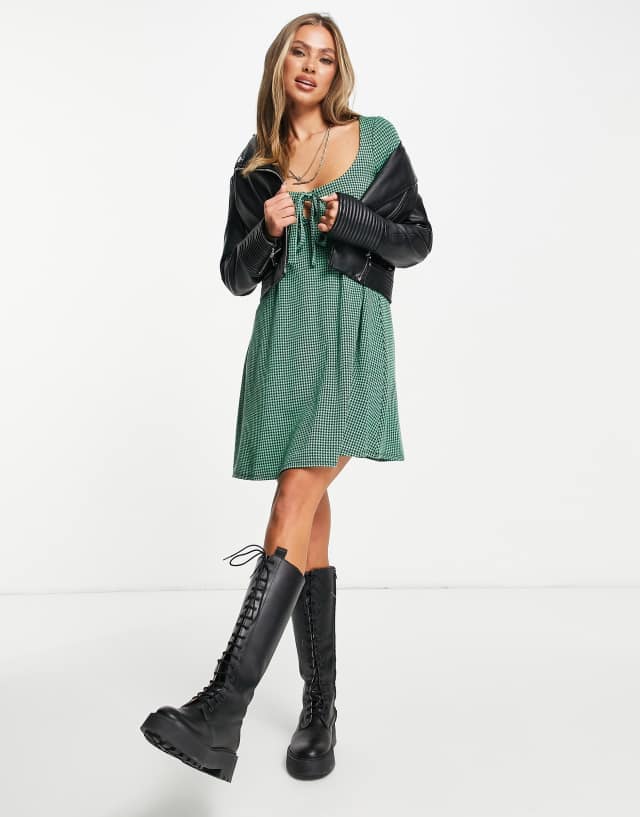 ASOS DESIGN mini babydoll dress with tie detail and long sleeve in green and black dogtooth print