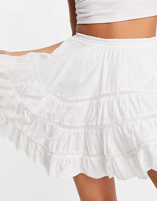 ASOS DESIGN mini skirt with hanky hem and lace insert in white