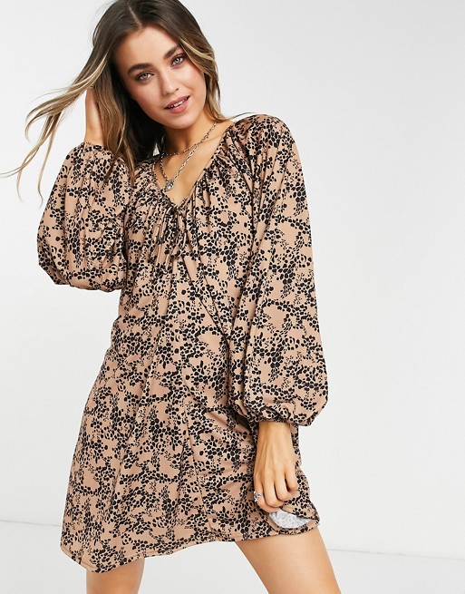 ASOS DESIGN mini smock dress with long sleeves and tie neck detail in animal print