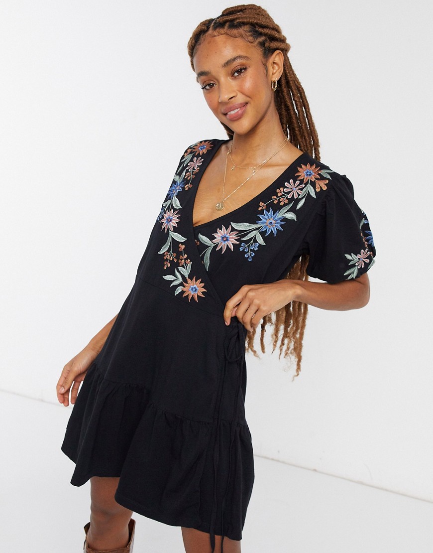 ASOS DESIGN mini wrap dress with short puff sleeves and tiered hem in black and floral shoulder embroidery
