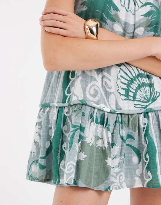 ASOS DESIGN - Mini-zonnejurk met halternek, stroken en brede biezen in gemengde blauwe print , 3 van 4
