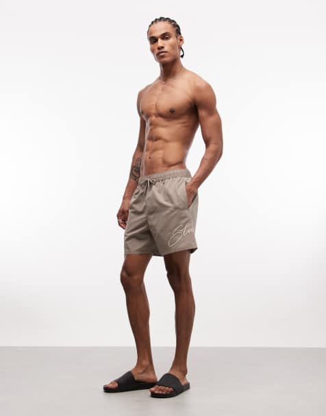 ASOS DESIGN – Mittellange Badeshorts in Braun mit Stickerei - view 1