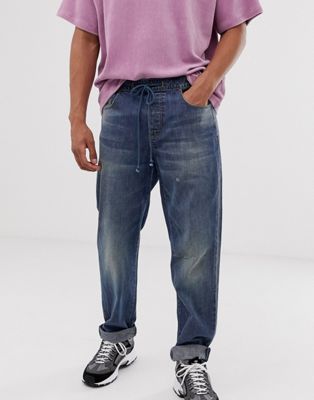 ASOS DESIGN – Mörkblå, tvättade jeans i säckig modell med dragsko