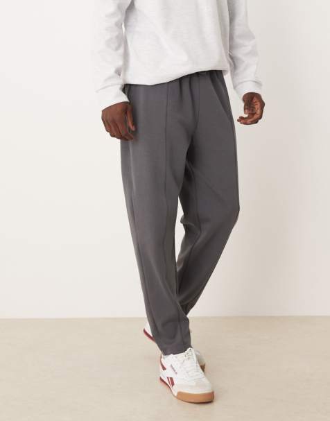 ASOS DESIGN – Mörkgrå, avsmalnande mjukisbyxor med stråveck - view 1