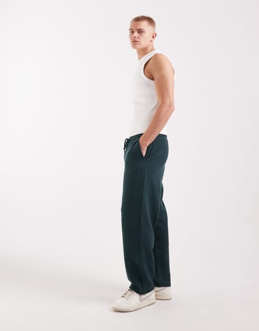 ASOS DESIGN – Mörkgröna, avsmalnande mjukisbyxor med avslappnad passform, 2 av 5