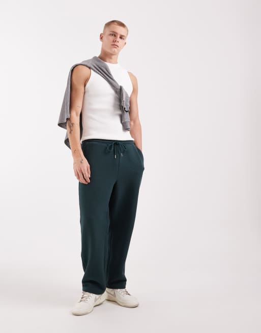 ASOS DESIGN – Mörkgröna, avsmalnande mjukisbyxor med avslappnad passform, 3 av 5