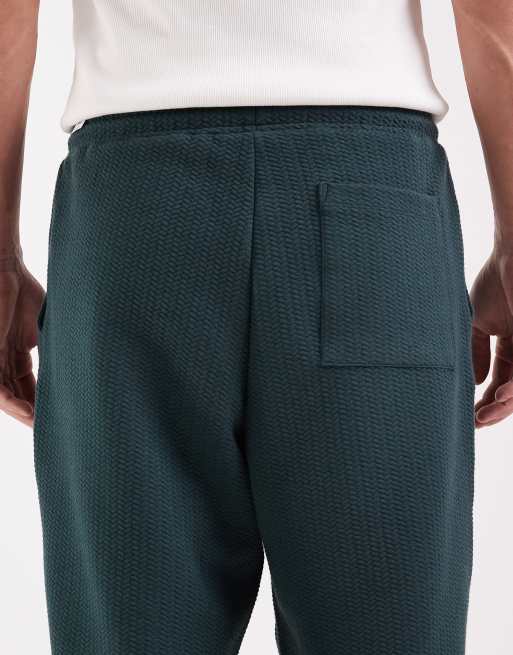 ASOS DESIGN – Mörkgröna, avsmalnande mjukisbyxor med avslappnad passform, 4 av 5