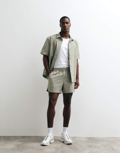 ASOS DESIGN motionMAX shorter length shorts with curved hem in sage green - view 1
