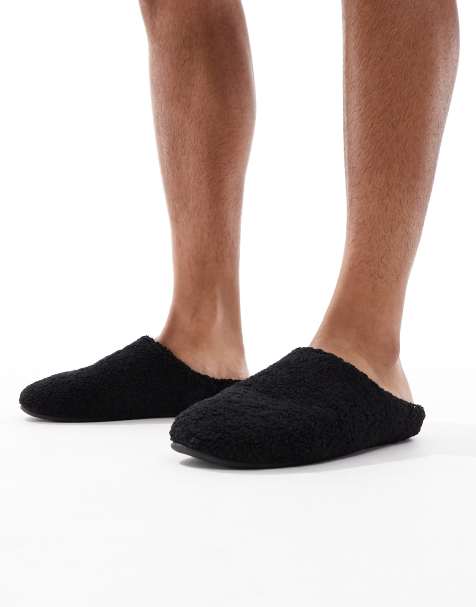 ASOS DESIGN mule slippers in black borg - view 1
