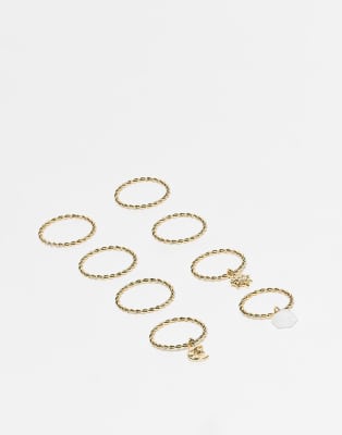 ASOS DESIGN multi-pack of rings with pendant charms detailing in gold tone