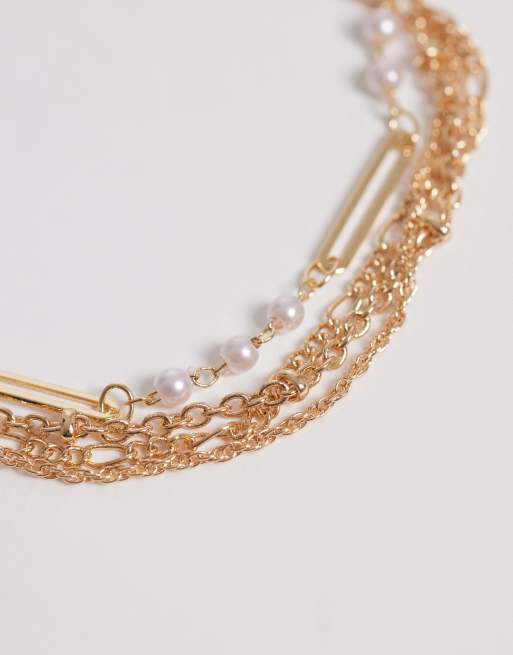 ASOS DESIGN multi-row chain bracelet with faux-pearl details in gold tone, 2 of 3