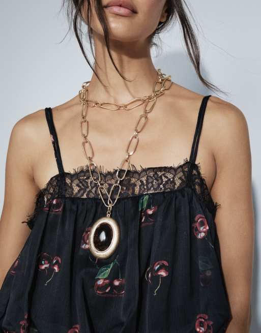 ASOS DESIGN multi-row necklace with large burgundy resin pendant in gold tone, 2 of 5