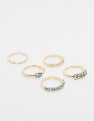 ASOS DESIGN - Multipack goldfarbener Ringe in verschiedenen Designs, mit blauen Schmucksteinen und Zierperlen