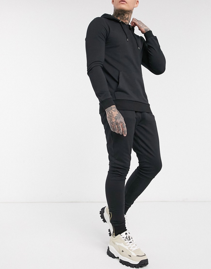ASOS DESIGN muscle tracksuit with hoodie & gold zip joggers in black
