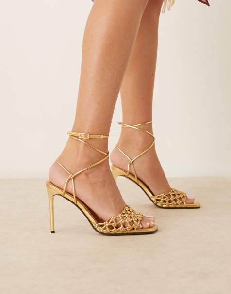 ASOS DESIGN – Nadine – Guldfärgade, högklackade sandaler med knutar - view 1