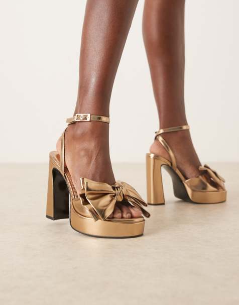 ASOS DESIGN Nala oversized bow platform heel sandals in gold - view 1