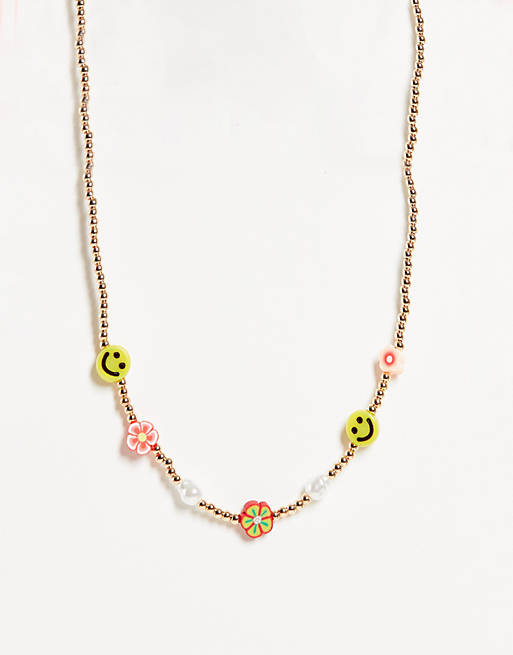 ASOS DESIGN necklace with flower and happy face beads in gold tone