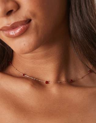 ASOS DESIGN necklace with gold tone fine chain and red semi-precious stone hearts