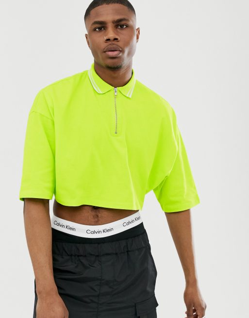 ASOS DESIGN – Neongrön kort pikétröja i oversize-modell med halvlång ärm, dragkedja upptill och kontrasterande ränder