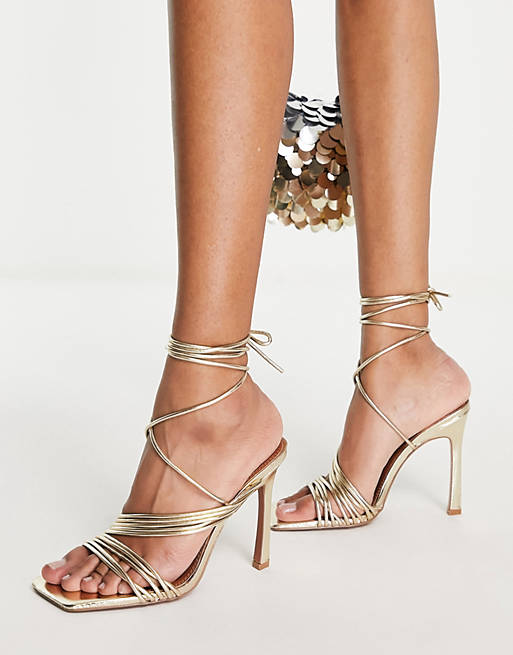 Booth Socialist Kan ASOS DESIGN Nest strappy tie leg heeled sandals in gold | ASOS