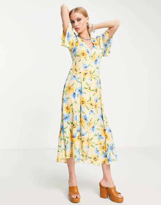 ASOS DESIGN - Nette midi-jurk met knoopjes, strik achter an engelenmouwen in perzikkleur met print van bloemen en stippen