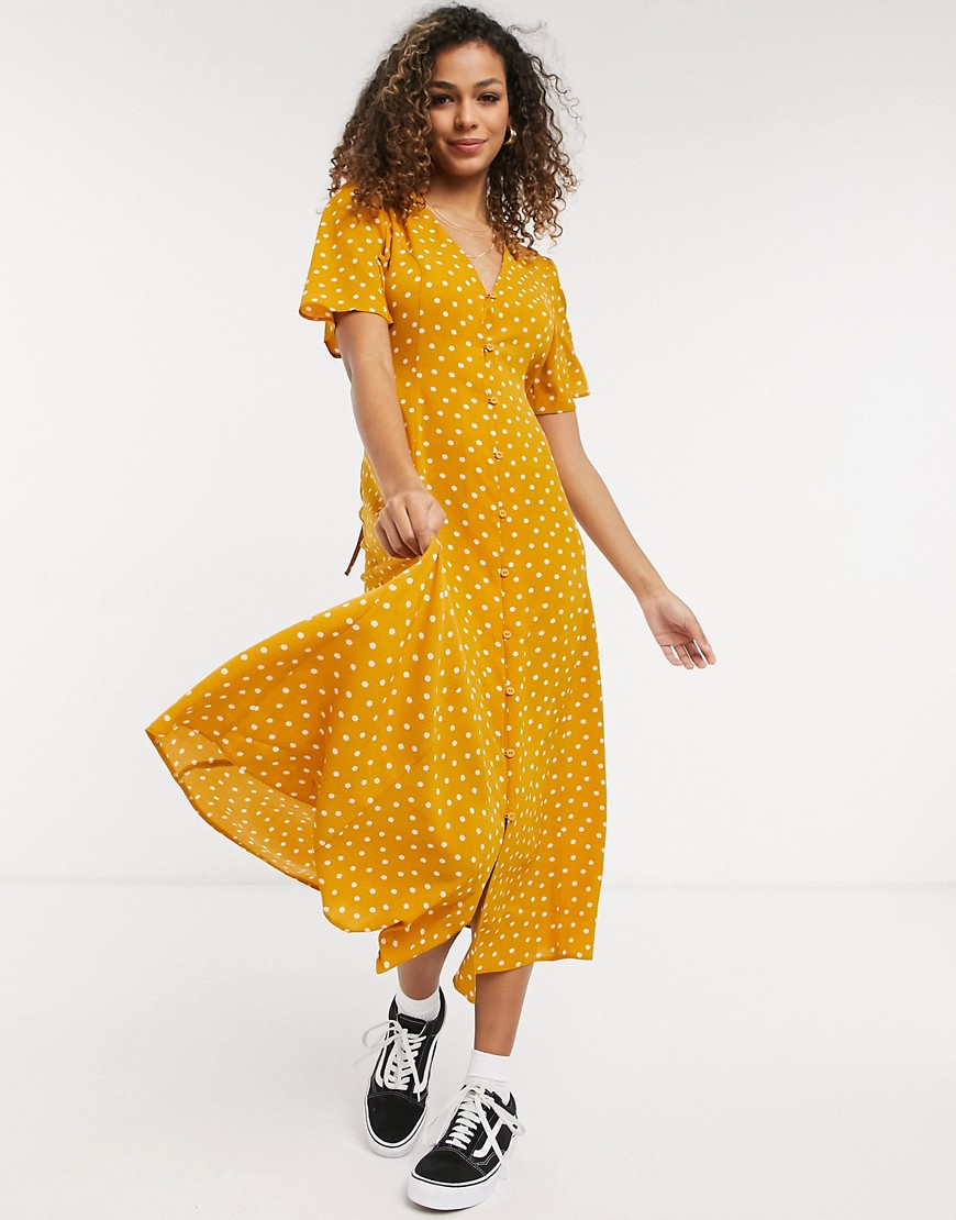 ASOS DESIGN - Nette midi jurk met knopen, gestrikte achterkant, uitlopende bouwen en stippen in mosterdgeel-Meerkleurig