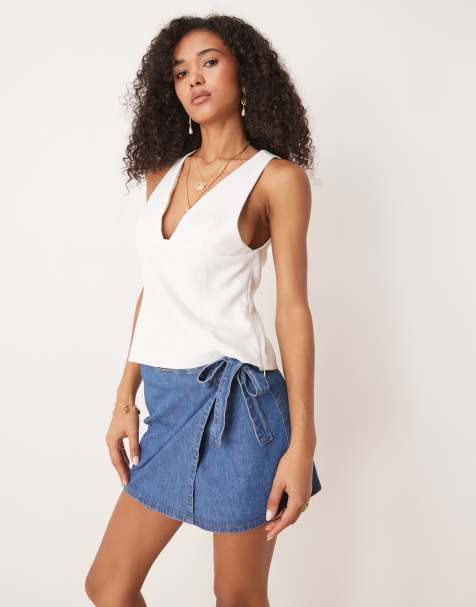 ASOS DESIGN denim wrap front mini skirt with bow detail in mid blue