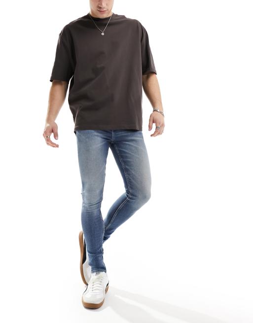 ASOS DESIGN – Niebieskie bardzo elastyczne jeansy o bardzo obcisłym kroju z efektem zabrudzenia