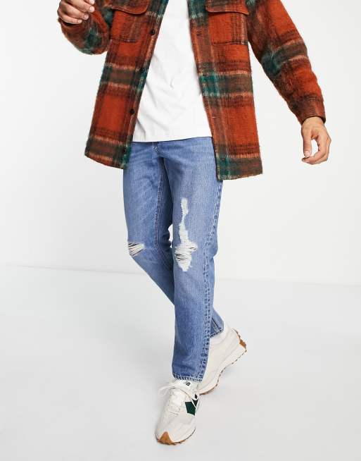 ASOS DESIGN – Niebieskie dopasowane jeansy w stylu vintage z rozdarciami na kolanach