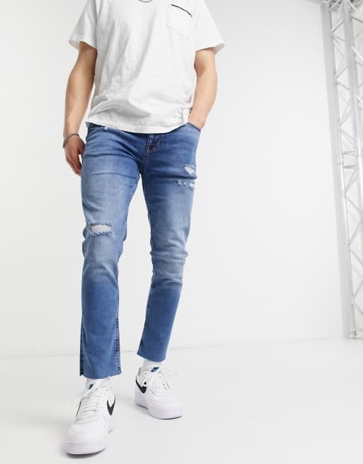 ASOS DESIGN – Niebieskie jeansy o obcisłym kroju z przetarciami i surowym wykończeniem