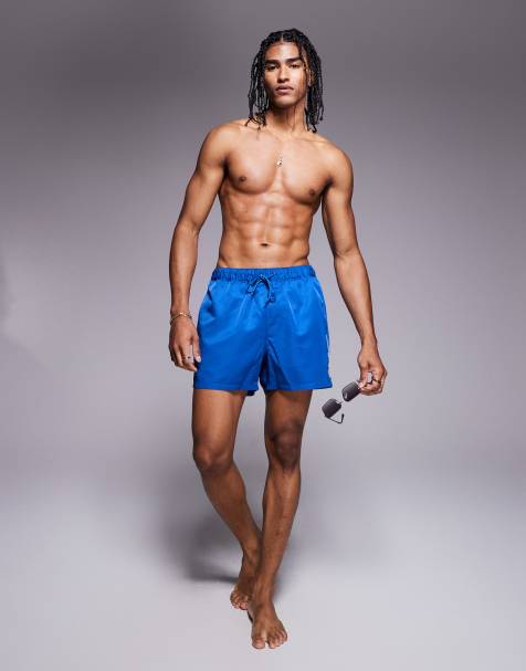 ASOS DESIGN swim shorts in short length with embroidery in blue