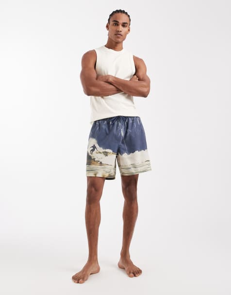 ASOS DESIGN – Niebieskie średniej długości szorty kąpielowe z surferskim nadrukiem - view 1