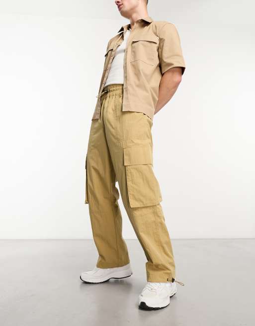 ASOS DESIGN - Nylon cargobroek met wijde pijpen en elastische taille in beige