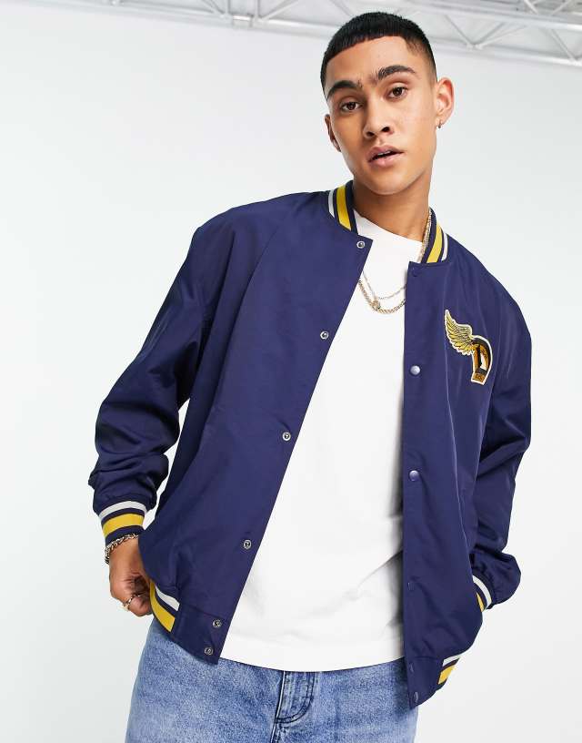 ASOS DESIGN nylon varsity jacket in navy and mustard