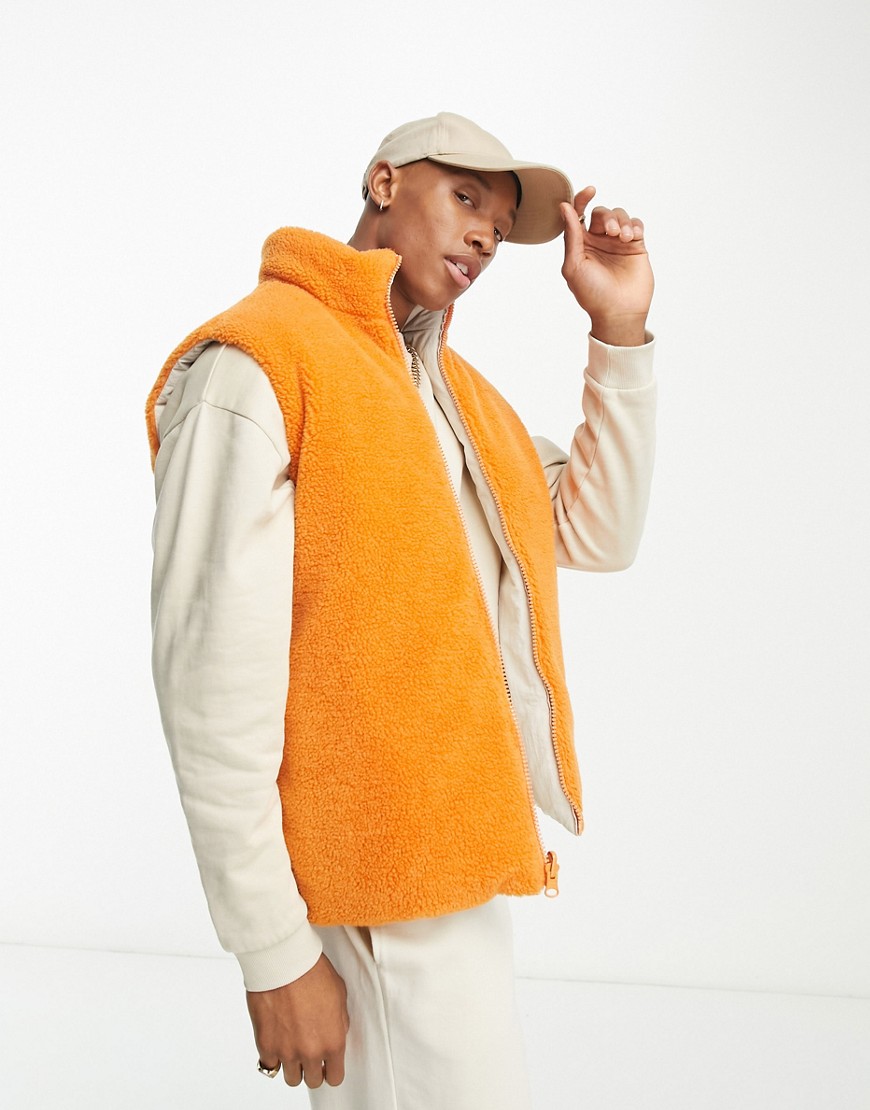 orange and white reversable puffer vest