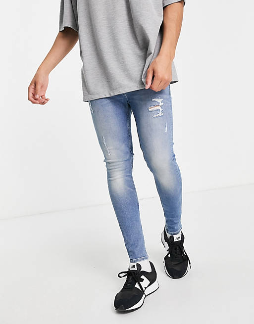 ASOS DESIGN spray on jeans with powerstretch in vintage light wash with abrasions
