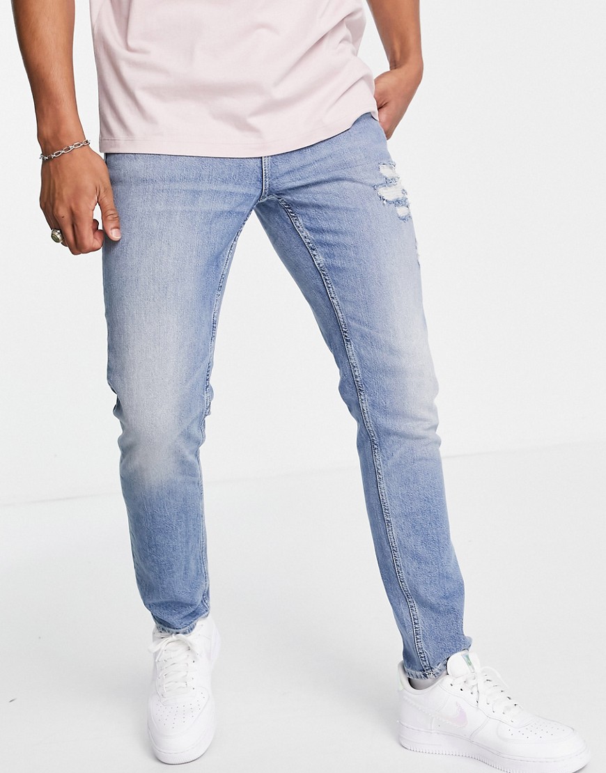 ASOS DESIGN Organic cotton blend stretch slim jeans in mid wash blue with abrasions-Blues