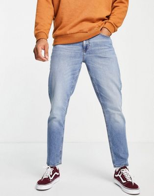 ASOS DESIGN tapered jeans in mid wash blue