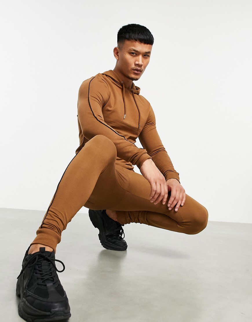 ASOS DESIGN organic muscle tracksuit with hoodie in brown with black contrast piping