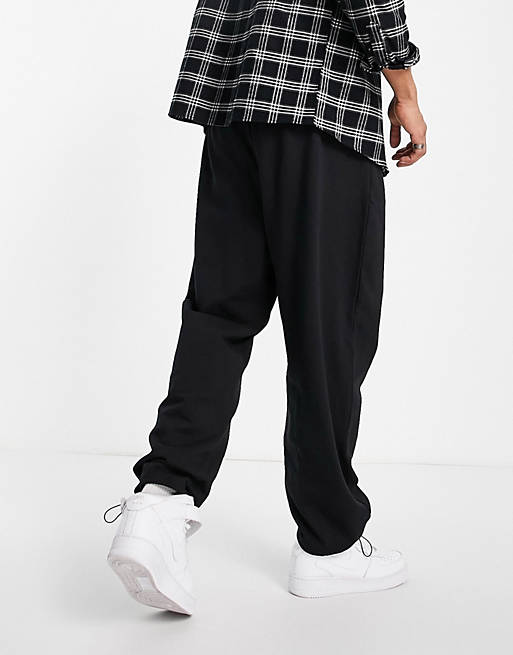 Tracksuits organic oversized joggers in black with toggle hem 