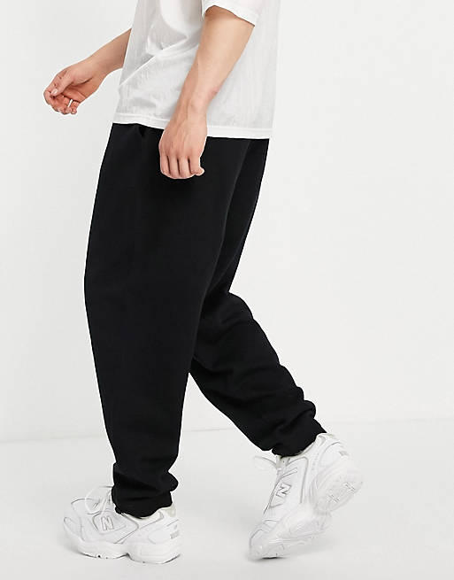Tracksuits organic oversized joggers in black with toggle hem 