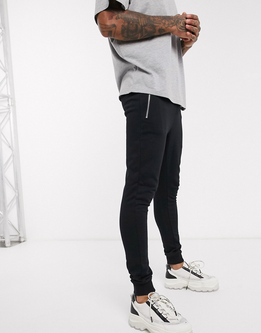ASOS DESIGN organic super skinny joggers in black with silver zip pockets